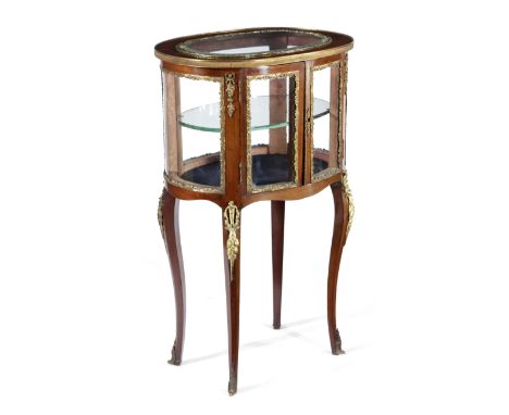 A FRENCH MAHOGANY OVAL VITRINE LATE 19TH CENTURY with ormolu mounts, the top with a bevelled glass panel above a pair of door