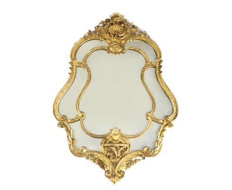 A GILTWOOD AND GESSO WALL MIRROR IN ROCOCO STYLE, LATE 19TH CENTURY the shaped plate within a leaf scroll and rocaile decorat