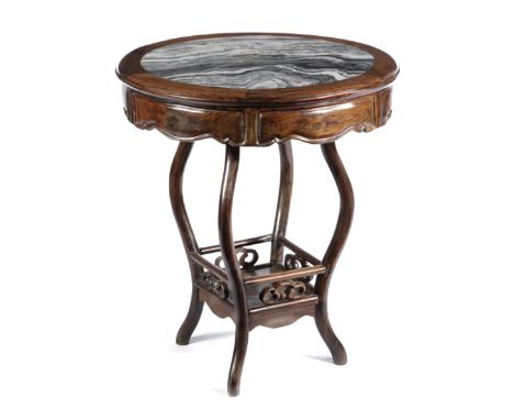 A CHINESE HARDWOOD TABLE LATE 19TH CENTURY the circular top inset with a marble panel, above curved legs united by an underti