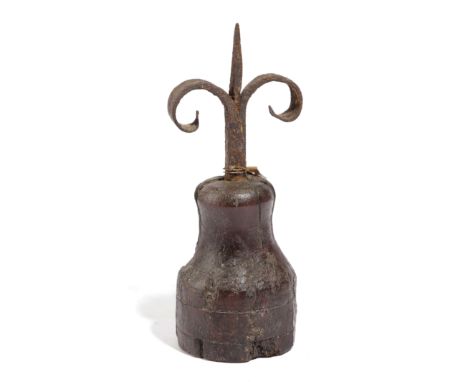 A LATE MEDIEVAL IRON PRICKET CANDLESTICK 15TH / 16TH CENTURY the central pricket with a pair of scrolls on a turned wood tree