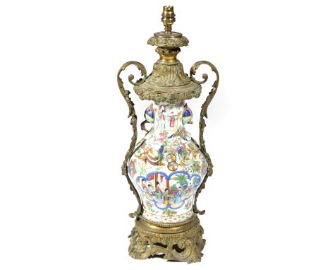 A CHINESE CANTON PORCELAIN AND ORMOLU MOUNTED TABLE LAMP 19TH CENTURY the vase decorated in the famille rose palette with pan