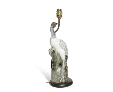 A CHINESE PORCELAIN TABLE LAMP IN THE FORM OF A CRANE LATE 19TH/EARLY 20TH CENTURY mounted on an ebonised wood base 35cm high