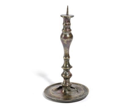 A EUROPEAN BRASS PRICKET CANDLESTICK VENETIAN OR GERMAN, C.1550 the spike on a slender stem with an inverted baluster, with d