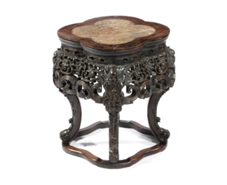 A CHINESE HARDWOOD STAND LATE 19TH CENTURY the lobed top inset with a marble panel above a pierced and carved frieze decorate