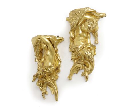 A PAIR OF GILTWOOD WALL BRACKETS OF ROCOCO FORM, LATE 19TH / EARLY 20TH CENTURY modelled as a cherub draped in cloths and sup