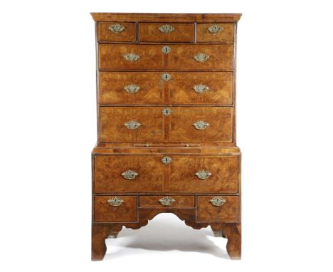 A WALNUT CHEST ON STAND EARLY 18TH CENTURY AND LATER with feather banding, the top with three short and three long burr venee