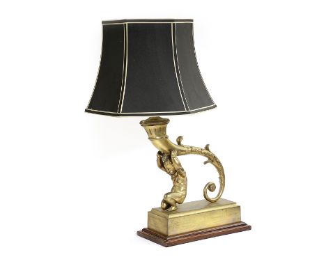 A GILT METAL CHERUB TABLE LAMP 20TH CENTURY modelled as a cherub supporting a cornucopia, on a rectangular base and mahogany 