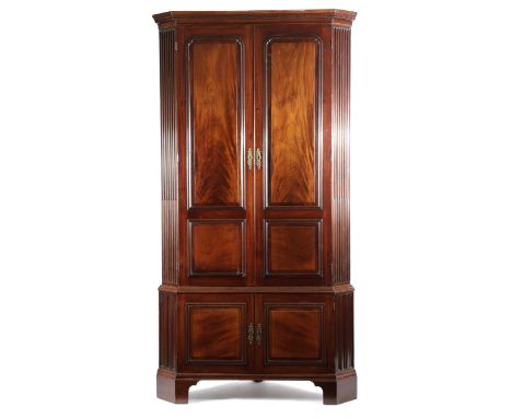 A GEORGE II MAHOGANY STANDING CORNER CUPBOARD ATTRIBUTED TO GILLOWS, C.1760 with a dentil cornice, above a pair of fielded pa