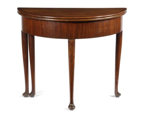 A GEORGE II MAHOGANY DEMI-LUNE CARD TABLE C.1740 the fold-over top on a single gate support with a baize lined interior with 