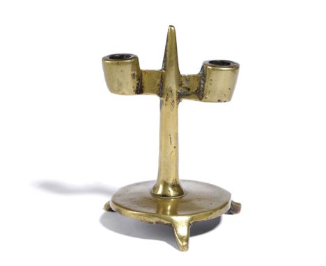 AN EARLY BRASS CANDLESTICK BRITISH OR NORTH EUROPEAN, 15TH CENTURY with a central pricket and twin socket arms on a tapering 