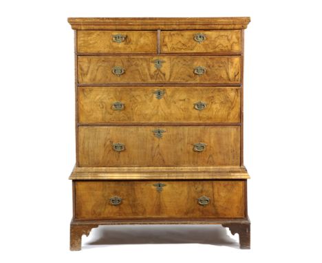 A WALNUT CHEST ON STAND EARLY 18TH CENTURY AND LATER with feather banding, the top with two short and three long drawers, the