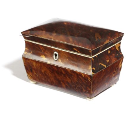 A REGENCY BLONDE TORTOISESHELL TEA CADDY EARLY 19TH CENTURY of shaped rectangular form, with a twin lidded interior with ivor