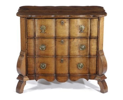 A DUTCH OAK COMMODE 18TH CENTURY the arc d'arbalete shaped top above three ripple front drawers 77.3cm high, 87.8cm wide, 50.