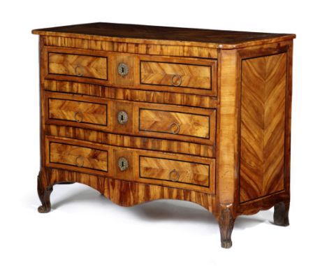 A NORTH ITALIAN WALNUT AND FRUITWOOD SERPENTINE COMMODE LATE 18TH CENTURY with three long drawers, on front leaf carved scrol