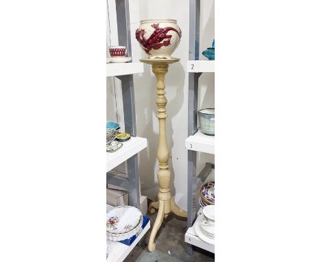Continental majolica jardiniere and a cream painted wooden tripod stand, the globular jardiniere moulded with dragons enriche