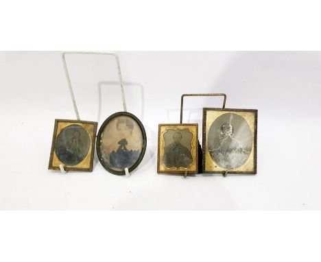Three 19th century gilt metal photograph frames enclosing photographic portraits and an oval metal frame enclosing a painted 