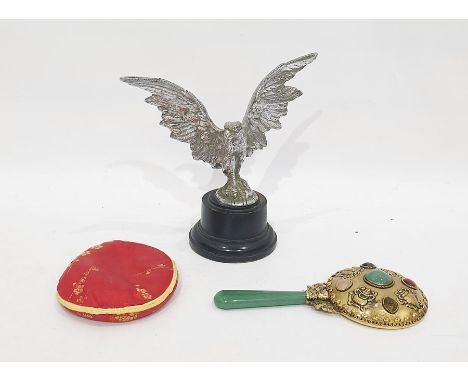 White metal sculpture of an eagle, on ebonised circular plinth, together with a gilt metal, stone and jade-style hand mirror,