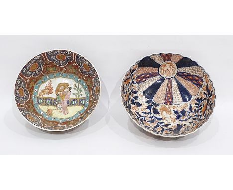 Two Asian porcelain bowls, the first decorated in the Imari palette, of fluted form, painted with mons and scrolling iron red