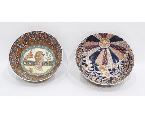 Two Asian porcelain bowls, the first decorated in the Imari palette, of fluted form, painted with mons and scrolling iron red