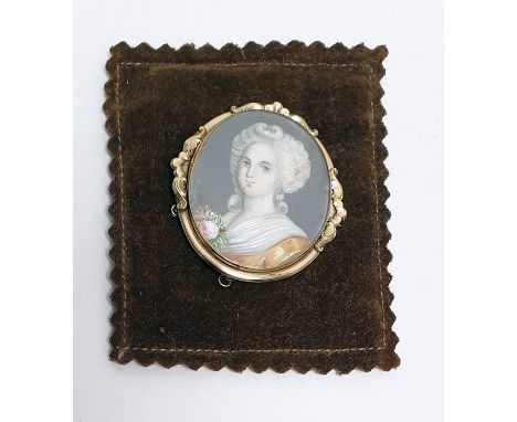 Gilt metal and miniature portrait brooch, the head and shoulders portrait of Georgian lady on ivory within scroll mount