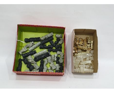 Two Chess sets, the first of carved onyx and the second of painted resin formed as tribal figures&nbsp;