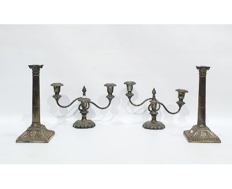 Two pairs of silver plated candlesticks, the first pair with three lights issuing from two branches with removable sconces an