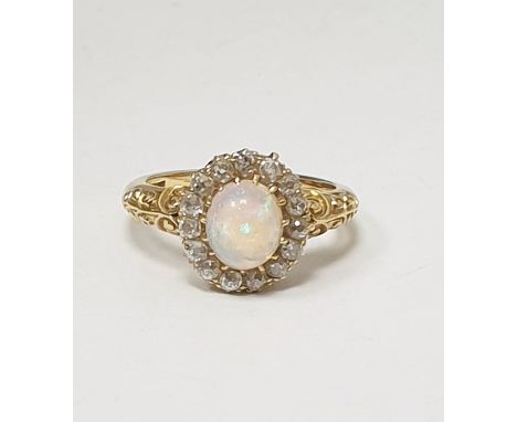 Antique 18ct gold, opal and diamond ring, the central oval cabochon opal surrounded by band of old cut diamonds, claw set, sc