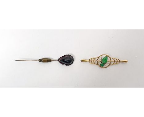 Gold-coloured metal and jade brooch having central spider with jade body and a garnet set stickpin with cabochon pear-shaped 