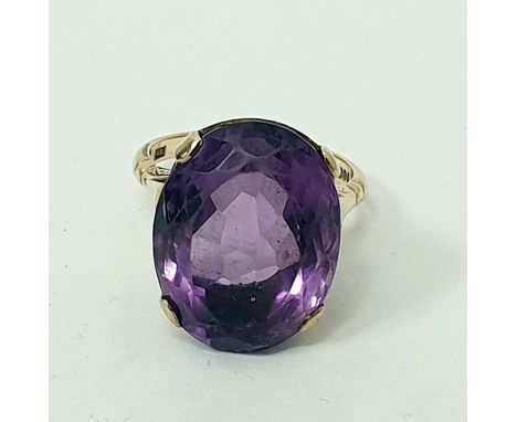 9ct gold ring set with large oval amethyst-coloured stone, claw set 