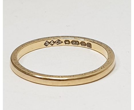 Fine 22ct gold wedding band with engraved decoration (worn), 2g approxCondition ReportThe ring size is K