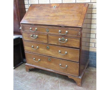 A George III walnut Bureau with finely fitted interior comprising six drawers, four pigeon holes and a central arched panelle