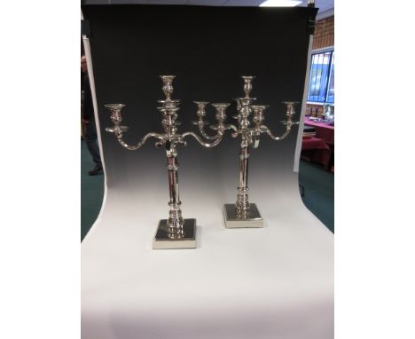 A pair of plated four branch, five light Candelabra on square bases, 22in