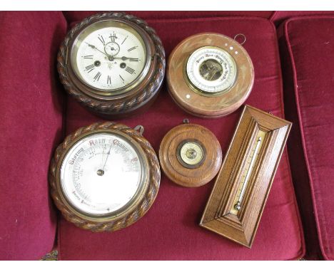 A circular Aneroid Barometer with leafage inlaid case, another with rope twist surround, a German circular Wall Clock with 8-