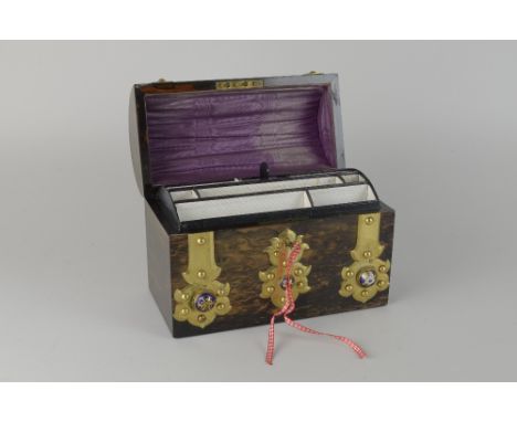 A 19th Century Coromantel Stationary Box with domes cover and brass strapwork decorated with blue enamel and fitted interior,