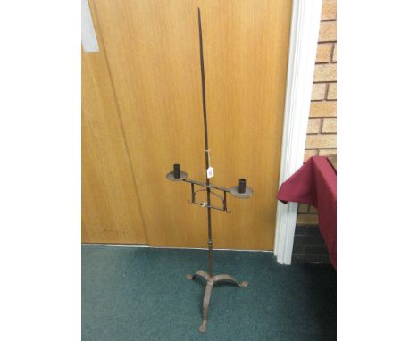 An antique cast iron Candle Stand with adjustable double sconce on tripod base