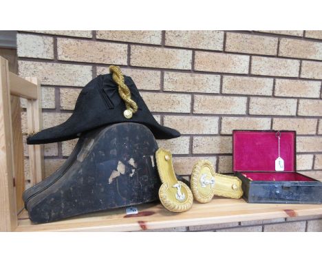An Admiralty bi-corn hat in box and a pair of epaulettes in tin
