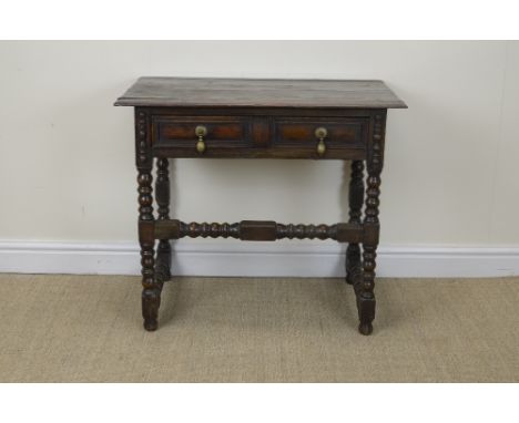 An antique oak Side Table fitted moulded frieze drawer on bobbin turned and squared supports, 2ft 8in W