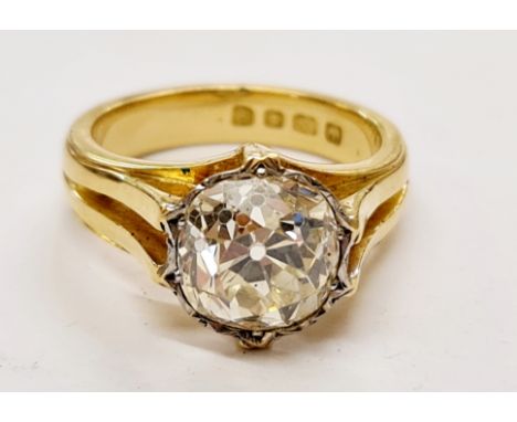 A hallmarked 18ct yellow gold diamond solitaire ring, set with a cushion cut diamond, measuring approx. 4.88ct, to split desi