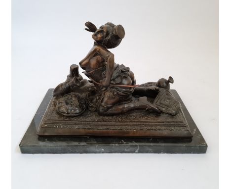 An erotic bronze figure of lady on rug with marble base length 33 1/2.