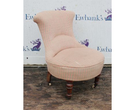 An Edwardian walnut nursing chair, on turned legs with ceramic casters, 78cm high