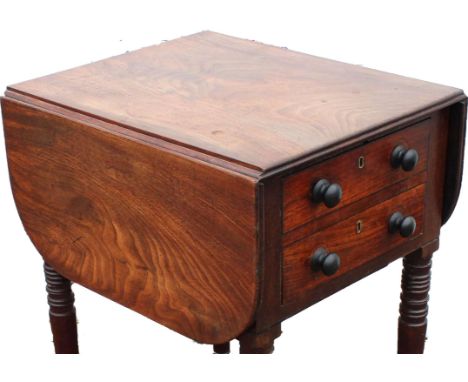 A George IV mahogany drop flap work table, 1820s, with a deep real drawer modelled as two drawers, on ring turned legs with c