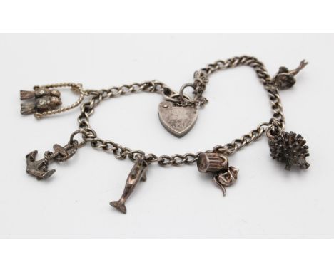 Vintage silver charm bracelet, with curb link chain and padlock heart clasp, with six charms, including love birds, articulat