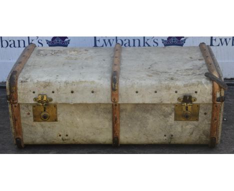 A mid 20th century vellum trunk, wood and metal bound and with leather side handles, interior formerly with tray, with maker'
