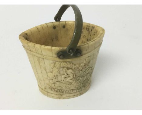 Early 19th carved bone bucket, possibly with anti-slavery message, of navette tapered form with metal swing handle, relief ca