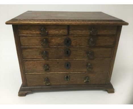 Georgian oak and pine miniature chest of drawers, with moulded top and two short over four graduated drawers, each with origi