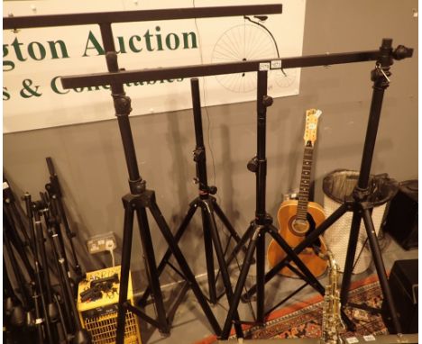 Four large black tubular steel stage speaker or lighting stands two with cross mounting bars
