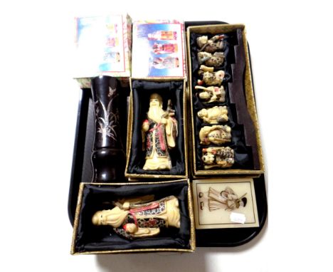 A tray of boxed ceramic and resin Japanese figures together with a lidded trinket box and a vase 