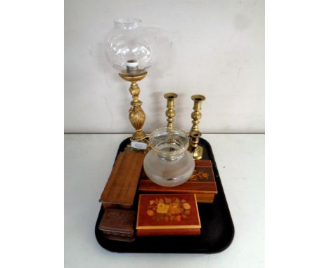 A tray containing two pairs of antique brass candlesticks, a brass embossed table lamp with glass shade, together with four a