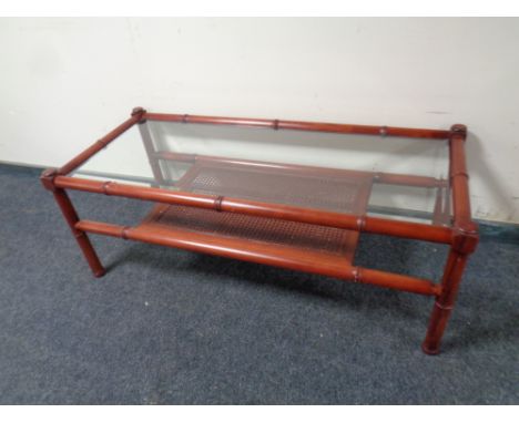 A bamboo and wicker glass topped conservatory coffee table with under shelf  