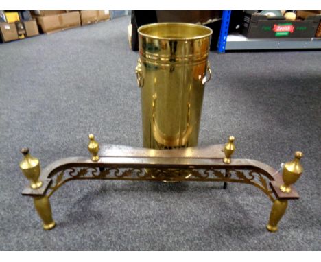 A brass lion mask handle stick pot together with a cast iron and brass fire front 